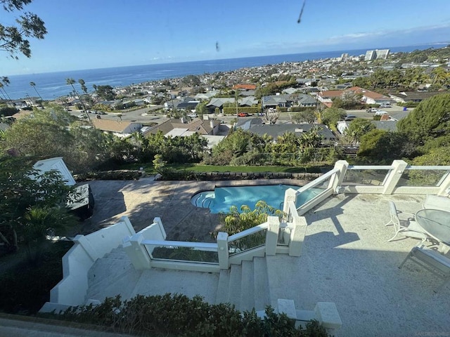 view of swimming pool featuring a water view