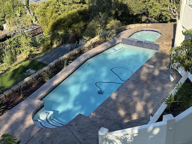 view of pool with an in ground hot tub