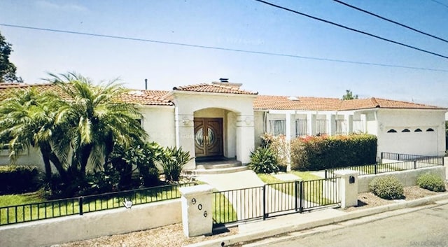 mediterranean / spanish home featuring a garage