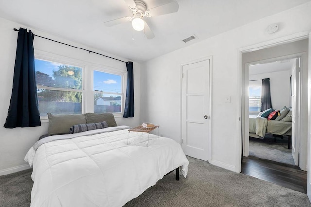 bedroom featuring ceiling fan and dark carpet