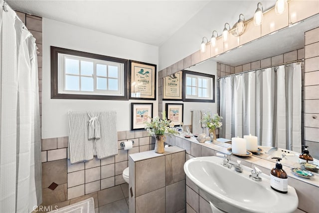 bathroom featuring sink, tile walls, tile patterned flooring, toilet, and a shower with shower curtain