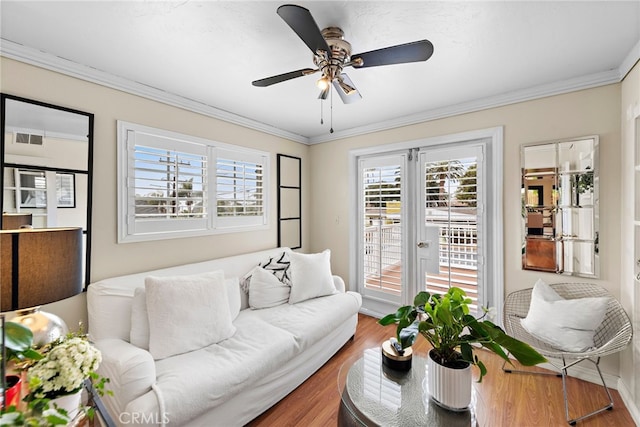 living room featuring hardwood / wood-style floors, crown molding, french doors, and ceiling fan