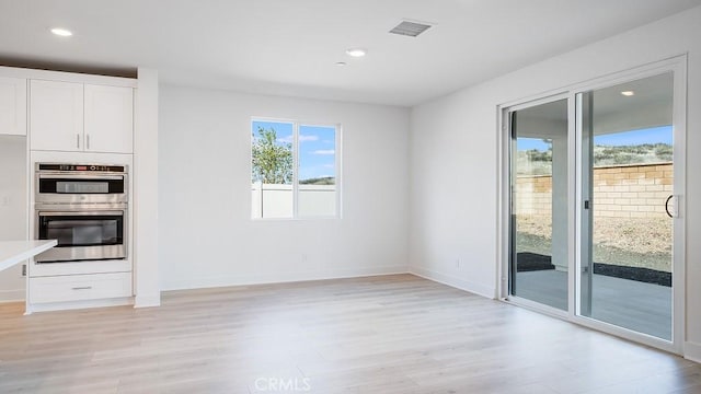 unfurnished dining area with visible vents, recessed lighting, and light wood-type flooring