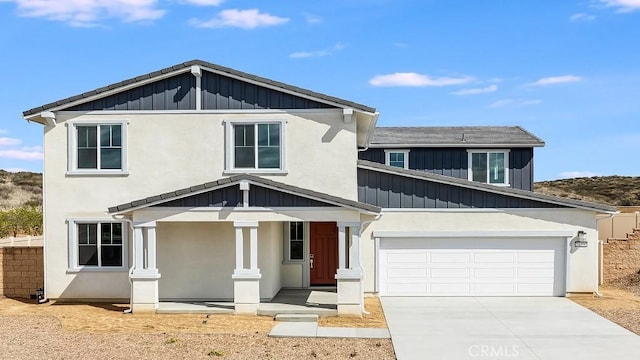 view of front of home featuring stucco siding, board and batten siding, and concrete driveway