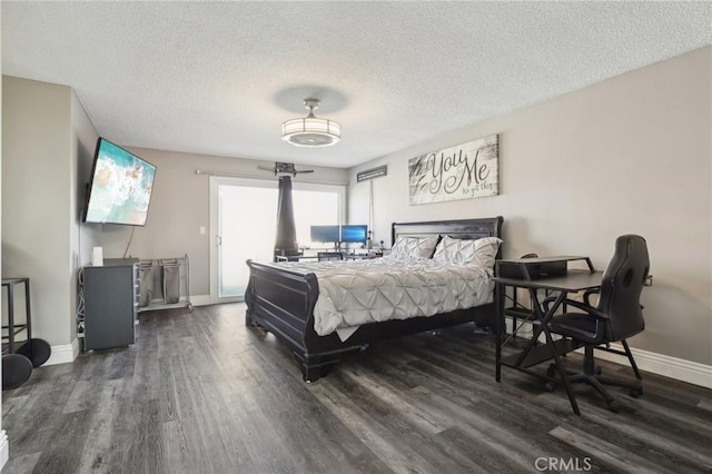 bedroom featuring dark hardwood / wood-style floors, access to outside, and a textured ceiling