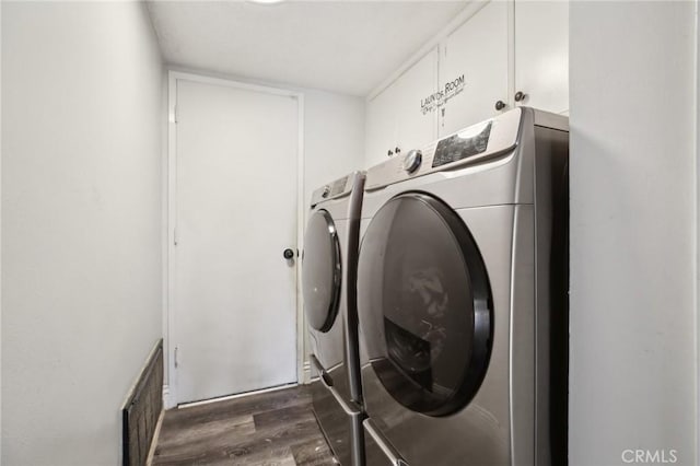 laundry room featuring washing machine and dryer and dark hardwood / wood-style floors