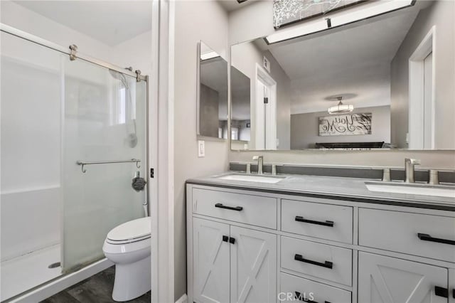 bathroom featuring vanity, toilet, and an enclosed shower