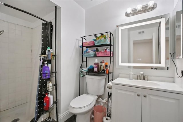 bathroom featuring vanity, toilet, and walk in shower