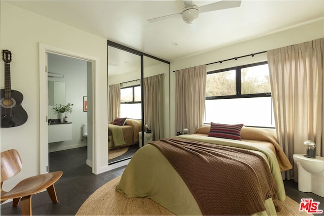 bedroom featuring ceiling fan, dark hardwood / wood-style floors, and a closet