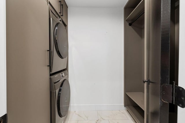 laundry room with stacked washing maching and dryer