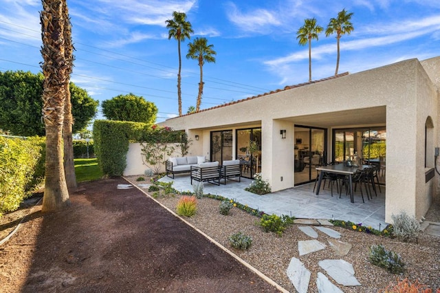 rear view of house with an outdoor hangout area and a patio