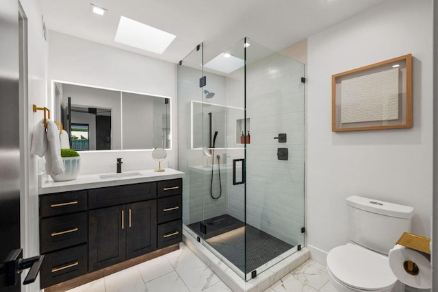 bathroom with vanity, a skylight, toilet, and walk in shower