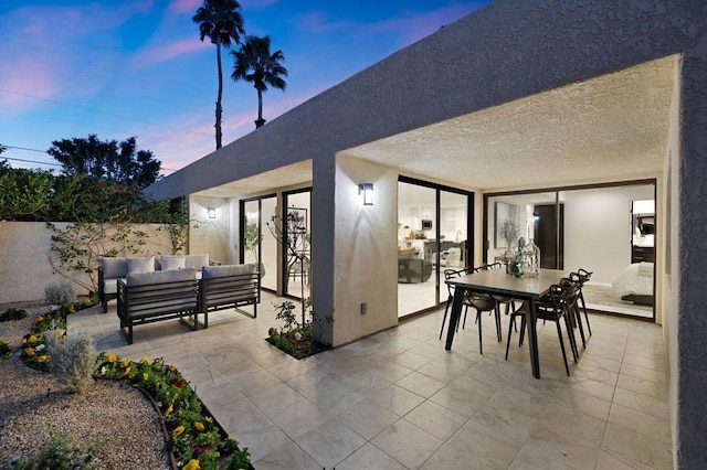 patio terrace at dusk with an outdoor living space