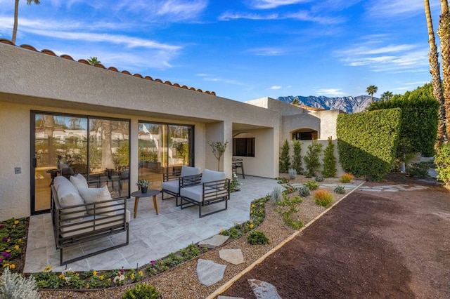 view of patio featuring outdoor lounge area and a mountain view