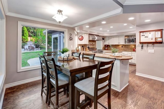 dining room with wood-type flooring and ornamental molding