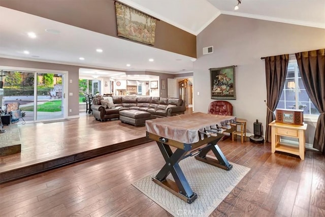 game room with hardwood / wood-style flooring, crown molding, and high vaulted ceiling