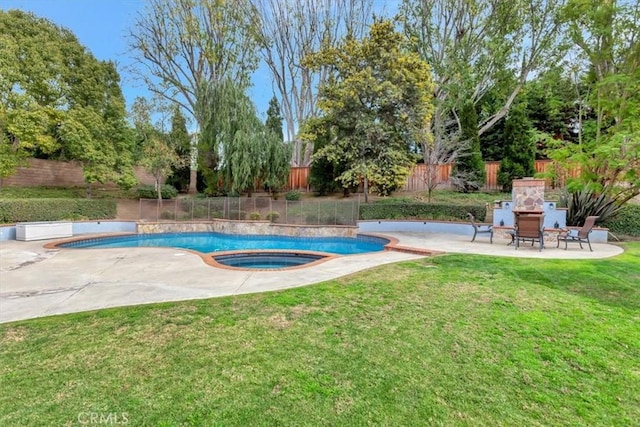 view of swimming pool with a yard, a patio area, an outdoor fireplace, and an in ground hot tub