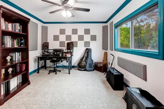 carpeted home office featuring crown molding and ceiling fan