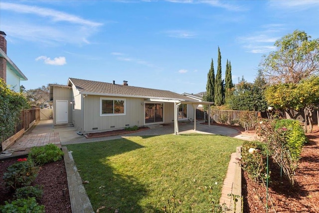 back of house featuring a patio and a lawn