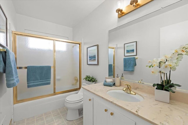 full bathroom featuring toilet, vanity, and shower / bath combination with glass door