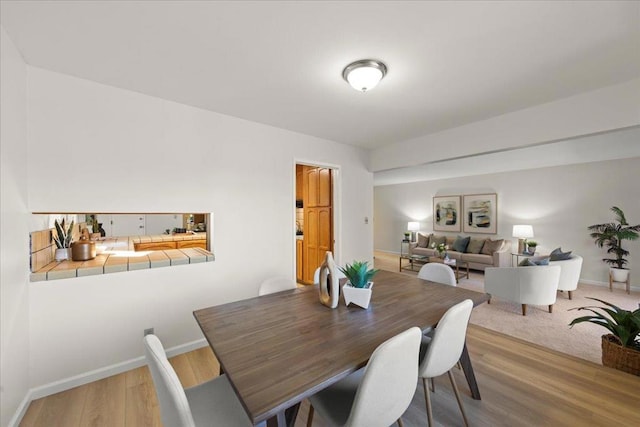 dining space with wood-type flooring