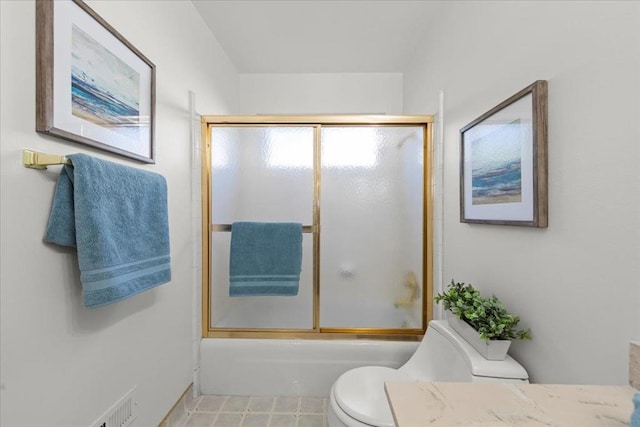 bathroom with enclosed tub / shower combo and toilet