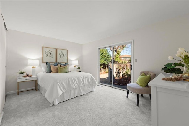 bedroom featuring light carpet and access to outside