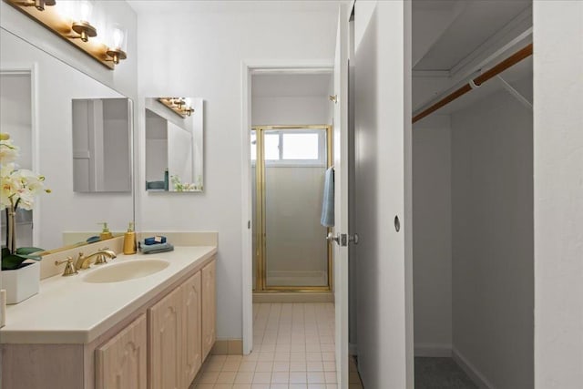 bathroom with tile patterned flooring, vanity, and a shower with shower door