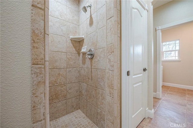 bathroom featuring tiled shower and tile patterned floors