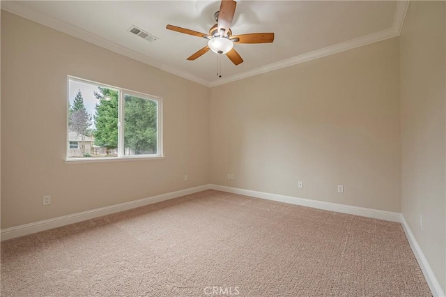 carpeted empty room with ornamental molding and ceiling fan