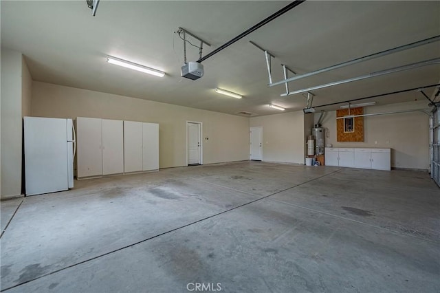 garage with a garage door opener, white fridge, and secured water heater