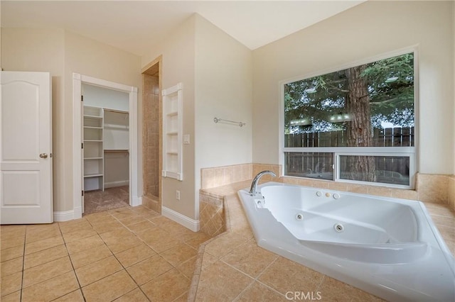 bathroom featuring tile patterned flooring and tiled tub