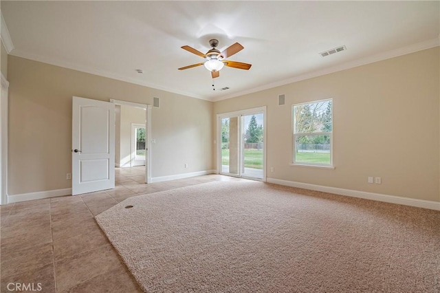 carpeted spare room featuring crown molding and ceiling fan