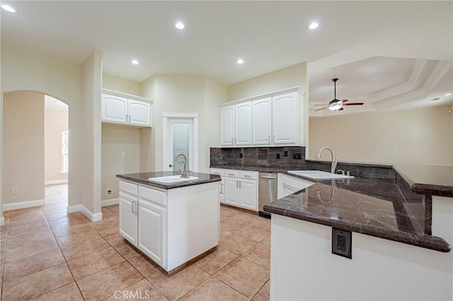 kitchen with sink, white cabinets, and kitchen peninsula