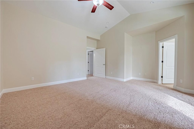 spare room with ceiling fan, high vaulted ceiling, and light carpet