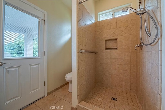 bathroom with plenty of natural light, a tile shower, tile patterned floors, and toilet