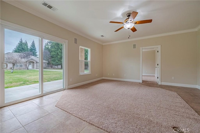 empty room with crown molding, ceiling fan, and light tile patterned floors