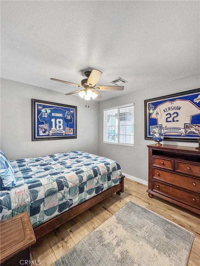 bedroom with ceiling fan and light wood-type flooring