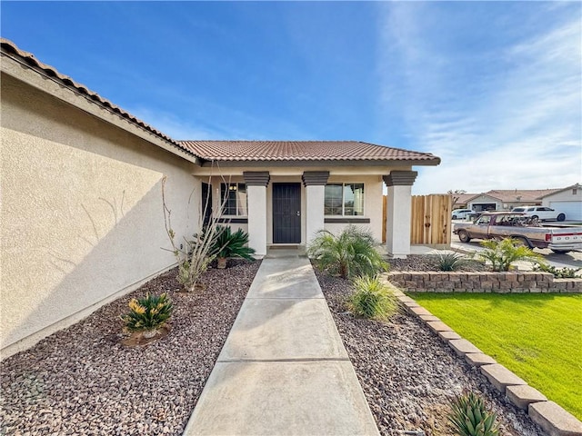 entrance to property featuring a yard