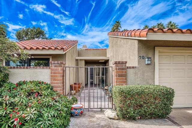 view of exterior entry with a garage