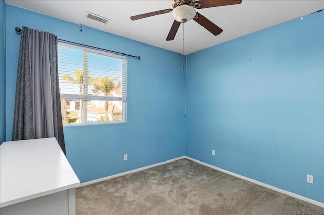 carpeted spare room with ceiling fan