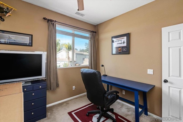 carpeted home office with ceiling fan