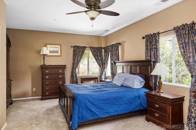 bedroom featuring light colored carpet and ceiling fan