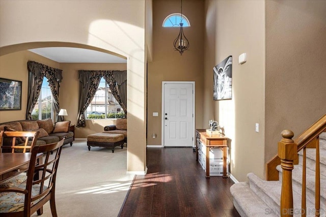 foyer featuring dark hardwood / wood-style flooring and a high ceiling