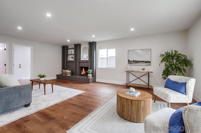 living room with hardwood / wood-style flooring and a fireplace