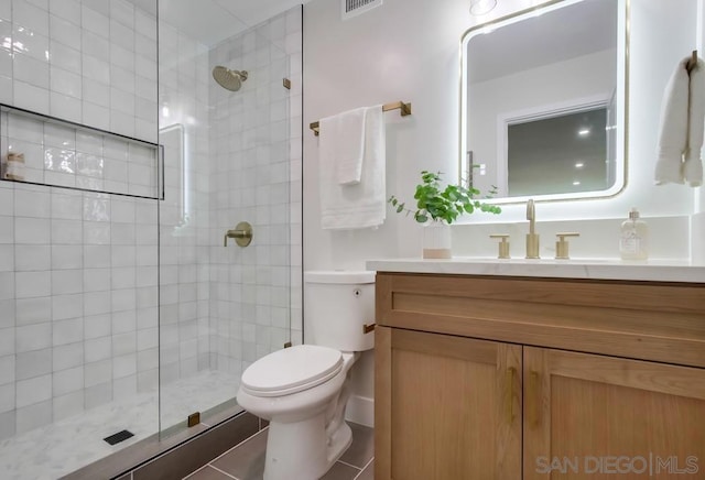 bathroom with vanity, toilet, and walk in shower