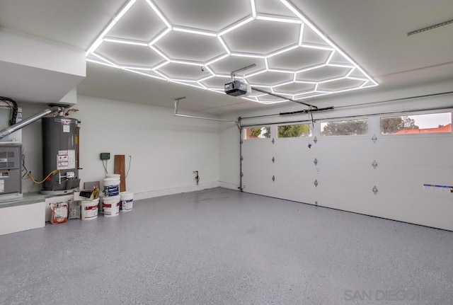 garage with water heater and a garage door opener