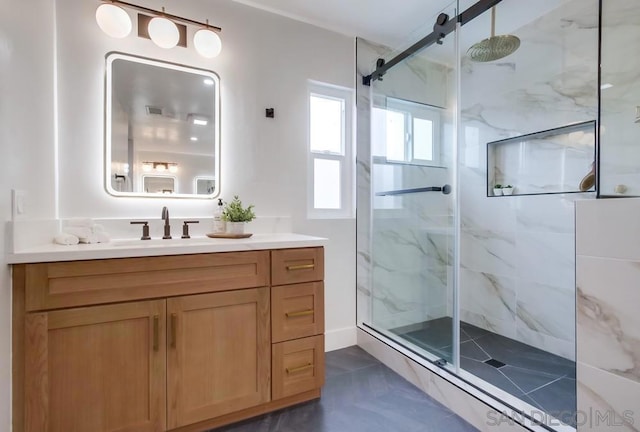 bathroom featuring vanity and a shower with door