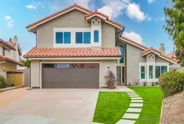 mediterranean / spanish-style house featuring a garage and a front yard