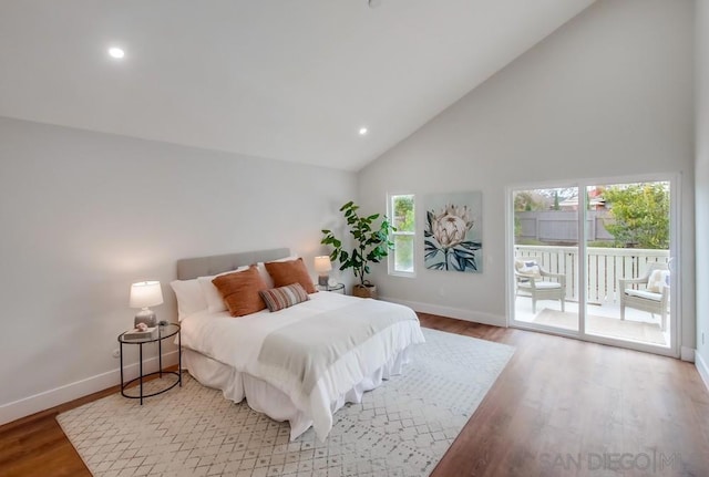 bedroom with high vaulted ceiling, access to exterior, and light hardwood / wood-style floors